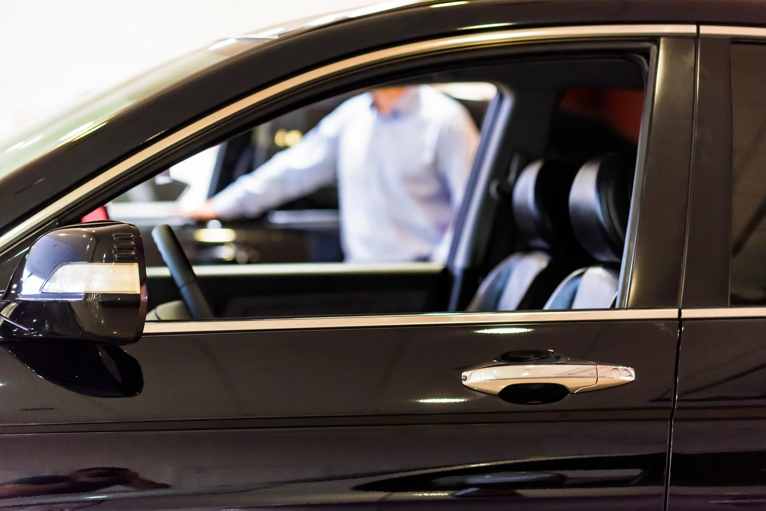 New car at dealer showroom blurred background