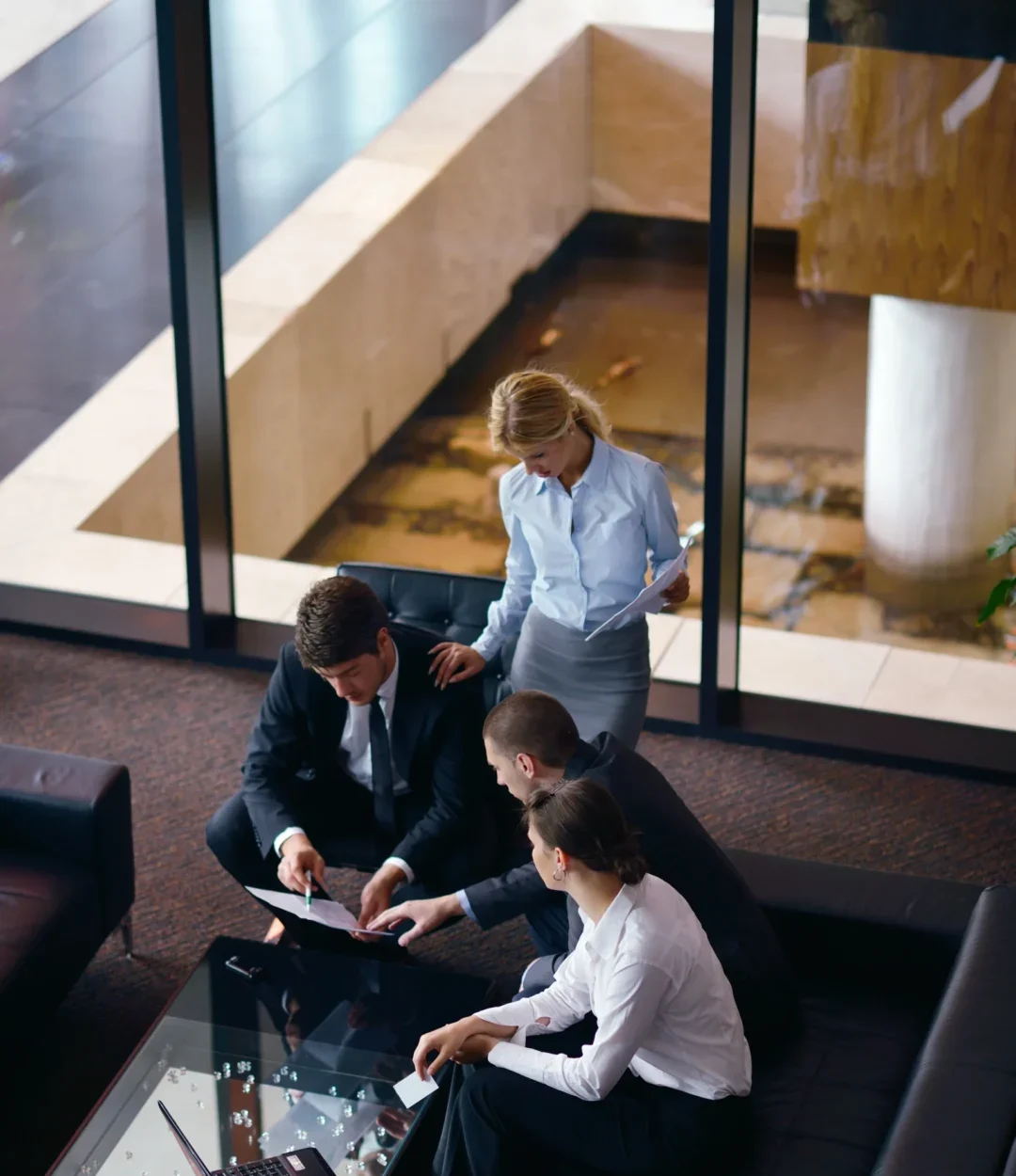Group of business people discussing business plan in the lobby of the modern office