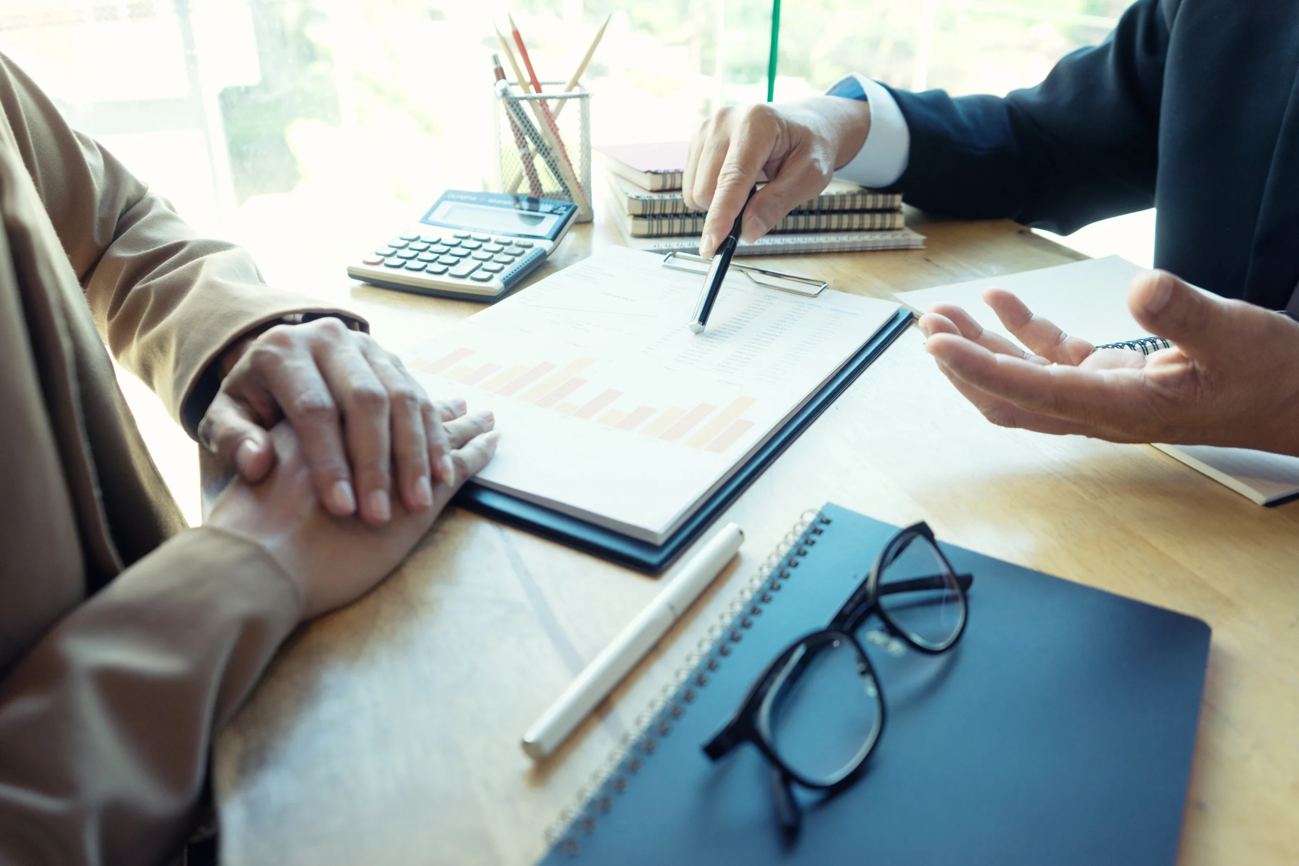teamwork work in the office meeting and consult about the business project use graph chart on the table